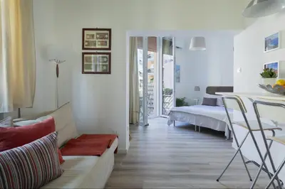 a living room with a couch and a bed at Le case di Frelli in Palermo