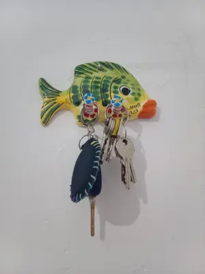 a fish key holder on a wall with a bunch of keys at Appartamenti Blu Mare in Castellammare del Golfo