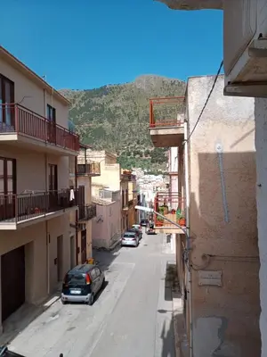 an alley with cars parked on a street with buildings at Appartamenti Blu Mare in Castellammare del Golfo