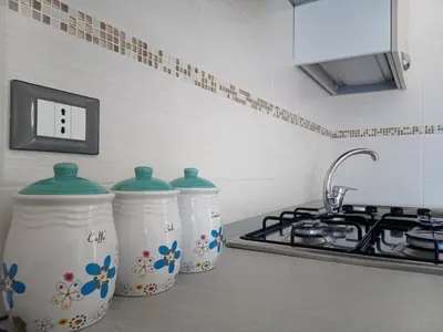 two milk containers sitting on a counter in a kitchen at Appartamenti Blu Mare in Castellammare del Golfo