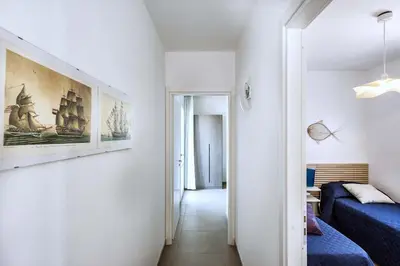 a room with a bed and a painting on the wall at Lisca Bianca in San Vito lo Capo