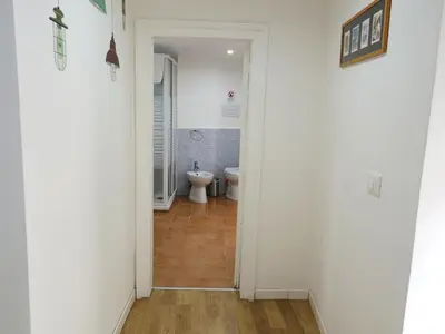 a hallway with a bathroom with a toilet at Home Maletto in Palermo