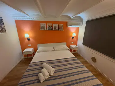 a bedroom with a bed and a large screen at Home Maletto in Palermo