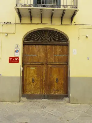 a large wooden door on the side of a building at Home Maletto in Palermo