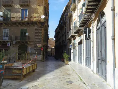 an alley in an old town with buildings at Home Maletto in Palermo