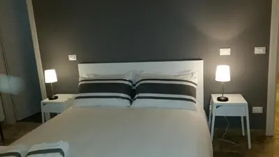 a bedroom with a large white bed with two night stands at B&B Casa Rosellina in Palermo