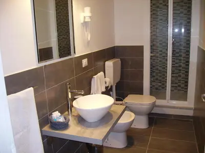 a bathroom with two toilets and a sink at B&B Casa Rosellina in Palermo