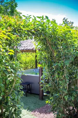 a bath tub in a garden with a bush at Le Zagare in Lascari