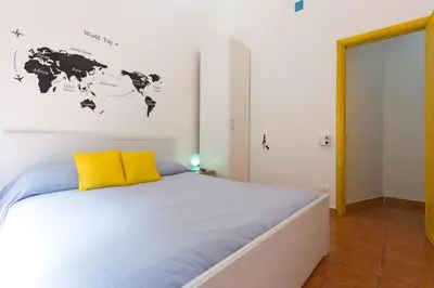a bedroom with a bed with a map of the world on the wall at Villa Mondello in Mondello