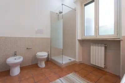 a bathroom with a toilet and a shower and a sink at Villa Mondello in Mondello