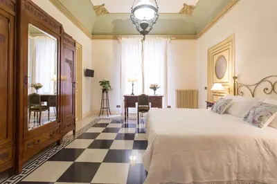 a bedroom with a bed and a checkerboard floor at B&B Porta Carolina in Palermo