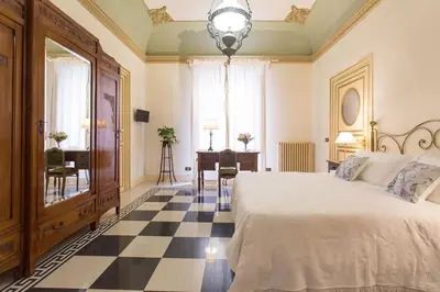 a bedroom with a bed and a checkerboard floor at B&B Porta Carolina in Palermo