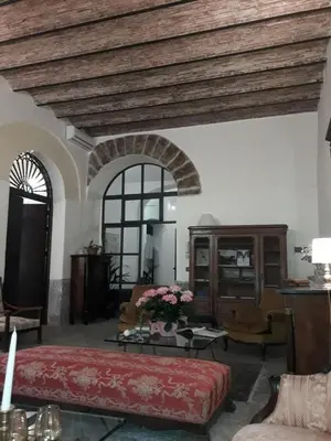 a large living room with a bed and a table at B&B Porta Carolina in Palermo