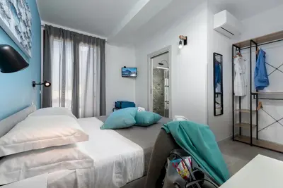 a hotel room with a bed and a window at Samira in San Vito lo Capo
