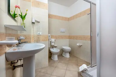 a bathroom with a sink and a toilet and a shower at Samira in San Vito lo Capo