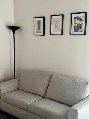 a living room with a couch and three pictures on the wall at Le Quattro Chiavi in Palermo