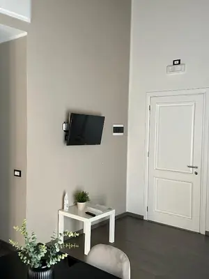 a white room with a door and a tv on the wall at Le Quattro Chiavi in Palermo