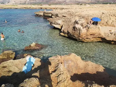 a group of people swimming in a body of water at Hawaii Siciliane in Castelluzzo