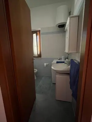a small bathroom with a sink and a toilet at Hawaii Siciliane in Castelluzzo