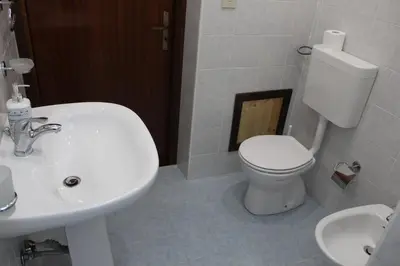 a bathroom with a white toilet and a sink at Appartamenti Via Marconi in Castellammare del Golfo