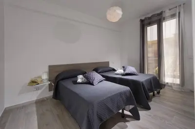 a bedroom with two beds and a window at La Suite Di Tyche in Castellammare del Golfo