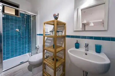 a bathroom with a sink and a toilet and a shower at La Suite Di Tyche in Castellammare del Golfo
