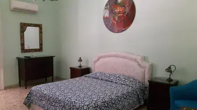 a bedroom with a pink bed and a mirror at Profumo di Sicilia in Palermo