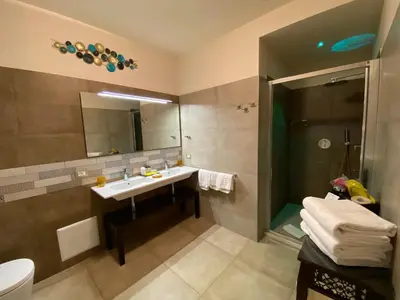 a bathroom with a sink and a mirror at RIAD Comfort Rooms in San Vito lo Capo