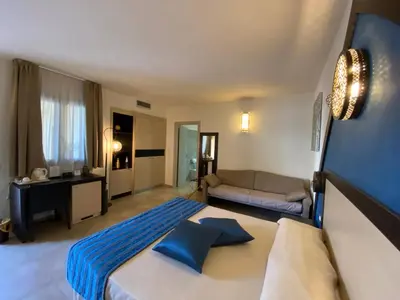 a large bedroom with a bed and a couch at RIAD Comfort Rooms in San Vito lo Capo