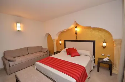 a hotel room with a bed and a couch at RIAD Comfort Rooms in San Vito lo Capo