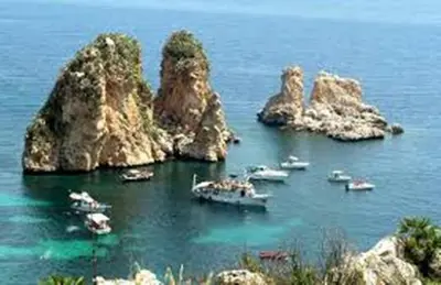 a group of boats in the water near some rocks at Casa Josephine in Balestrate