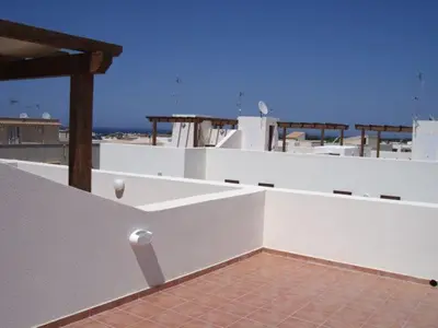 a white balcony with a view of the ocean at Case nel Giardino in San Vito lo Capo