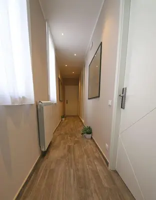 an empty hallway in an office building with wood floors at Le Cupole Design in Palermo