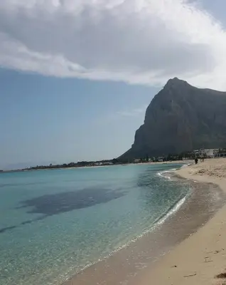 a view of a beach with a mountain in the background at Il Peperoncino in San Vito lo Capo