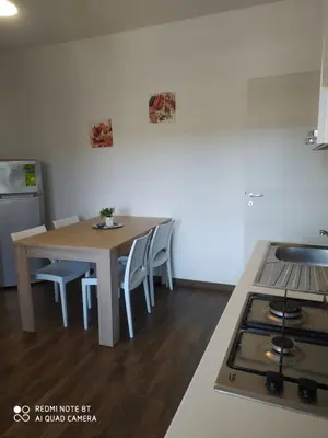 a kitchen with a table and chairs and a stove at Il Peperoncino in San Vito lo Capo