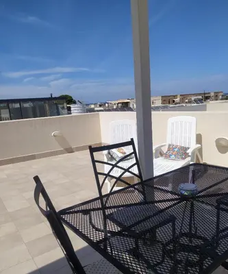 a table and two chairs on a roof at Il Peperoncino in San Vito lo Capo