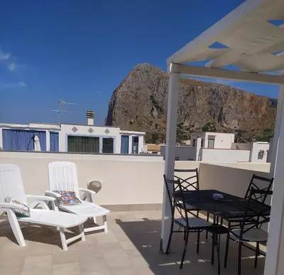 a group of chairs and tables on a patio at Il Peperoncino in San Vito lo Capo