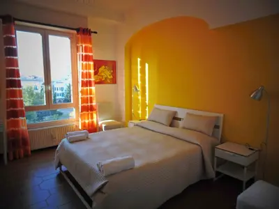 a bedroom with a large bed and a large window at Kemonia in Palermo