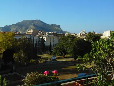 a view of a city with a mountain in the background at Kemonia in Palermo