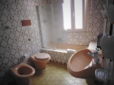 a bathroom with a sink and a toilet and a sink at Kemonia in Palermo