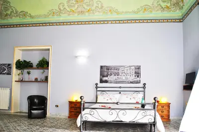 a bedroom with a bed and a ceiling at Antica Dimora in Palermo