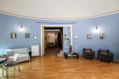 a living room with blue walls and a couch and tables at Antica Dimora in Palermo