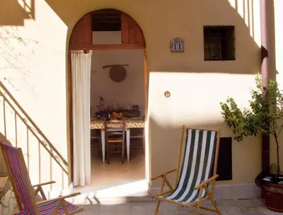 a patio with two chairs and a table at Soleluna in Castellammare del Golfo