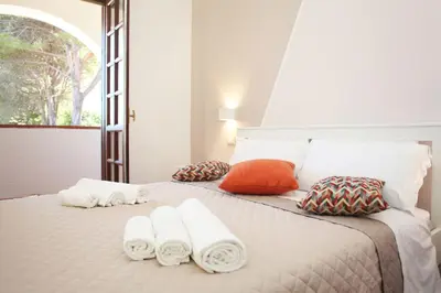 a bedroom with a bed with towels on it at Country Villa San Vito Bay in San Vito lo Capo