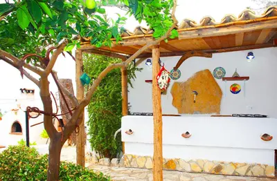 a house with a tree in front of it at Country Villa San Vito Bay in San Vito lo Capo