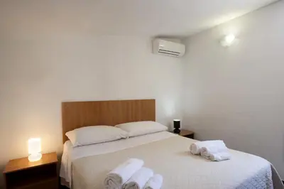 a bedroom with a bed with towels on it at Villetta Blusanvito in San Vito lo Capo