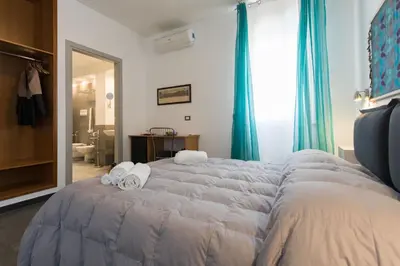 a bedroom with a large bed with towels on it at Duca di Villena in Palermo