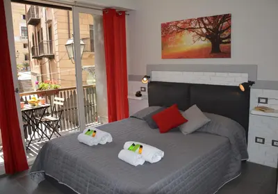 a bedroom with a bed with two pillows on it at Duca di Villena in Palermo