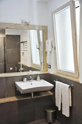 a bathroom with a sink and a mirror at Duca di Villena in Palermo