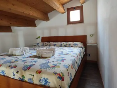 a bedroom with a large bed in a room at La Perla sul Golfo in Castellammare del Golfo